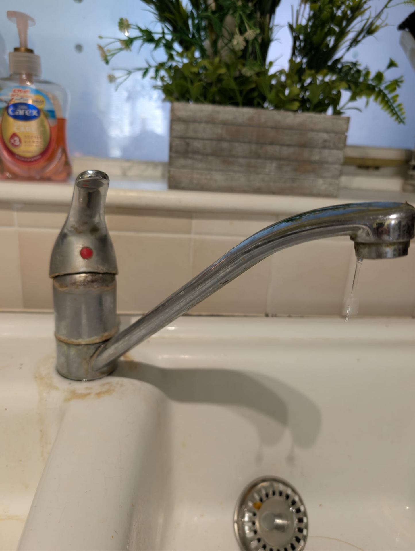 Old stained kitchen tap before replacement